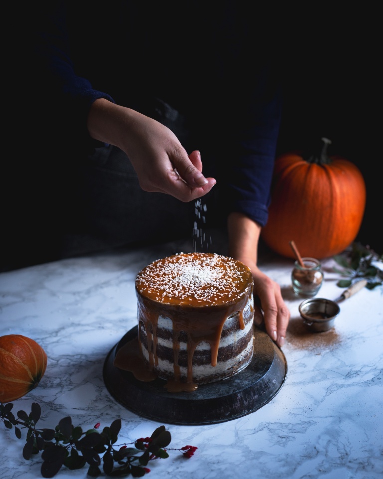 Topping a squash and carrot cake with coconut flakes